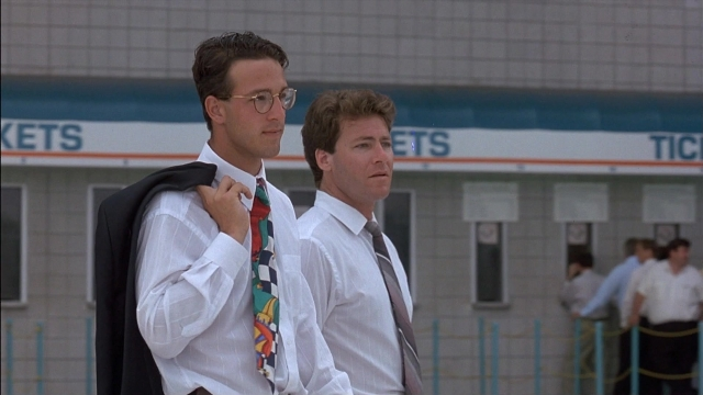Wide shot frame from Ace Ventura: Pet Detective — standing, walking, dialogue