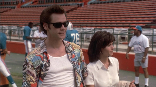 Wide shot frame from Ace Ventura: Pet Detective — standing, walking, shirt