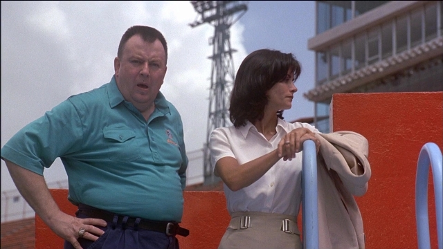 Wide shot frame from Ace Ventura: Pet Detective — standing, shirt, face