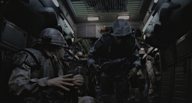 Wide shot frame from Aliens — standing, dialogue, car