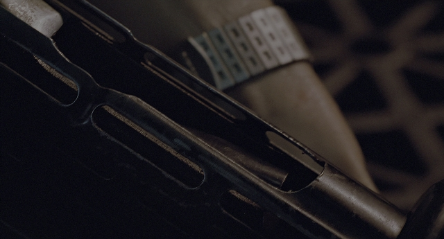Frame from Aliens — table, gun
