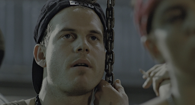 Close-up frame from Aliens — room, hat, face