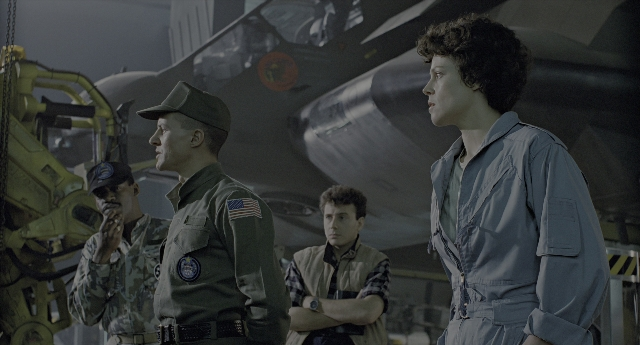 Wide shot frame from Aliens — standing, uniform, shirt
