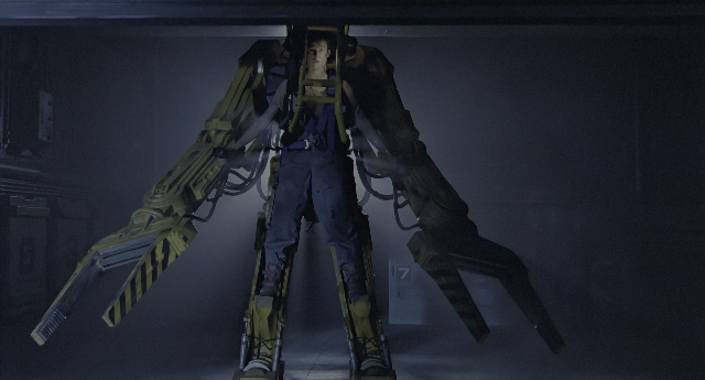 Wide shot frame from Aliens — standing, room, hat