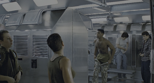 Wide shot frame from Aliens — standing, door, uniform