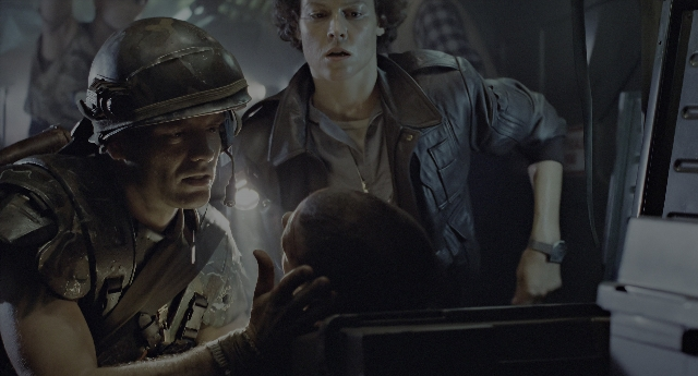 Wide shot frame from Aliens — sitting, standing, room