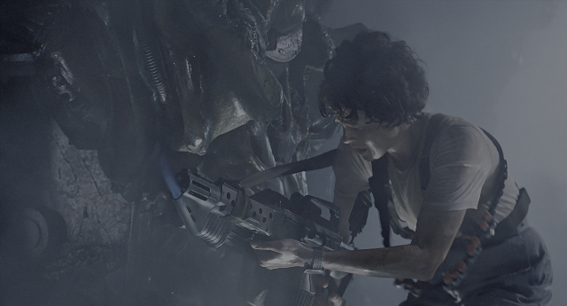 Wide shot frame from Aliens — shirt, gun, face