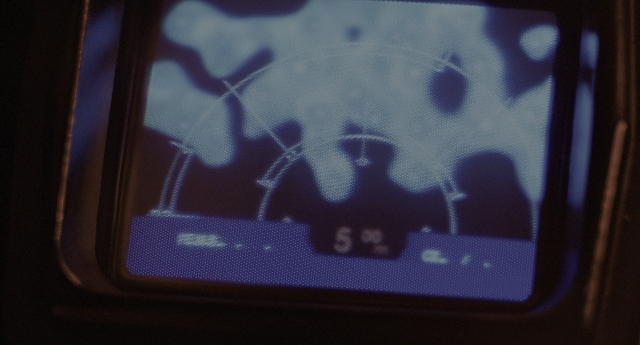 Wide shot frame from Aliens — television, face, person