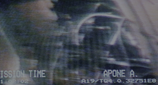 Wide shot frame from Aliens — face, forest, person