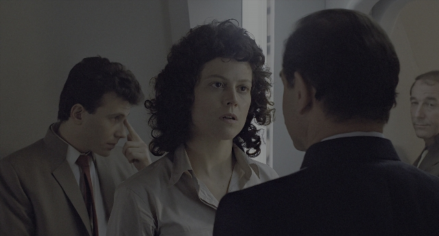 Wide shot frame from Aliens — standing, room, hand