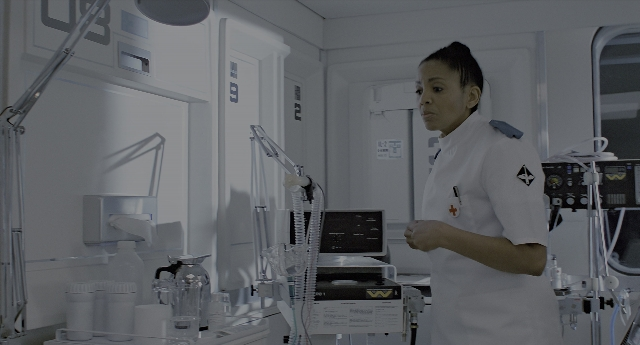 Wide shot frame from Aliens — standing, room, door