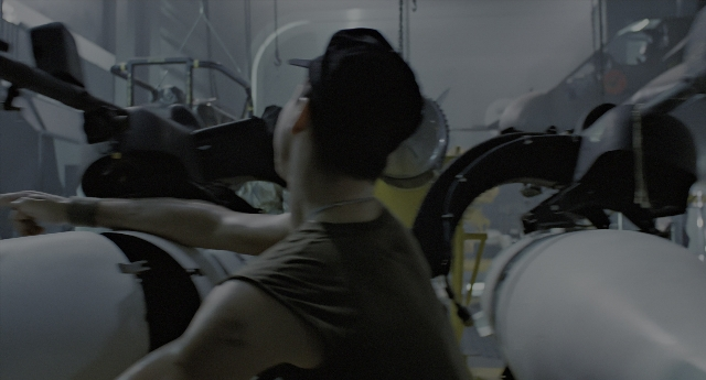 Wide shot frame from Aliens — standing, room, hat