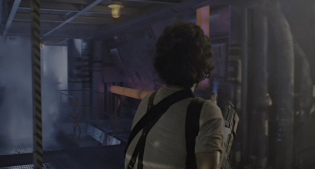 Wide shot frame from Aliens — standing, room, smoke