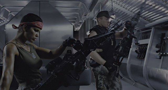 Wide shot frame from Aliens — standing, room, hat