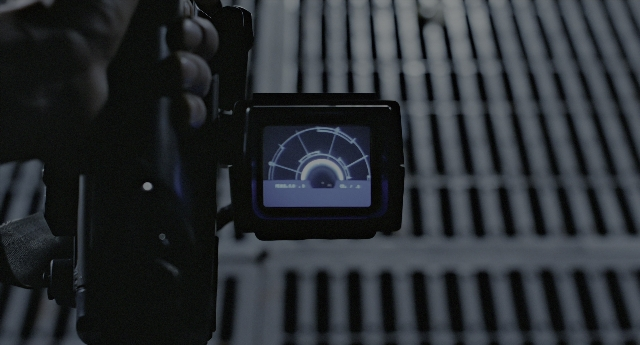 Wide shot frame from Aliens — hand, camera, person