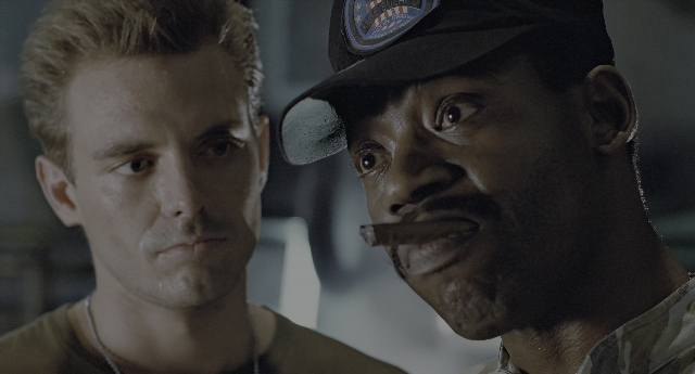 Close-up frame from Aliens — room, hat, shirt