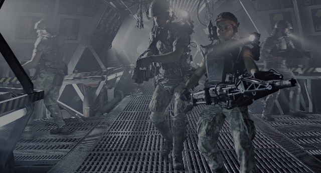 Wide shot frame from Aliens — room, person, human face