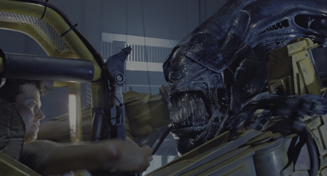 Wide shot frame from Aliens — room, car, hand