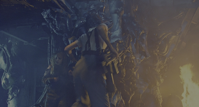 Wide shot frame from Aliens — standing, fire, smoke