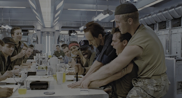 Wide shot frame from Aliens — room, table, food