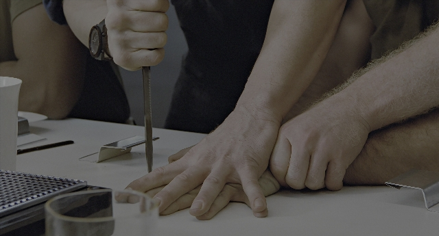 Wide shot frame from Aliens — table, person, human hand