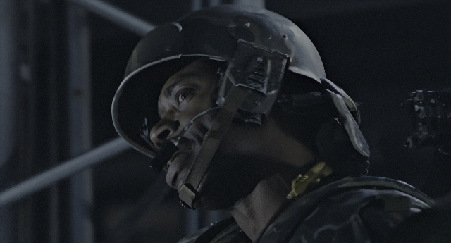 Wide shot frame from Aliens — room, hat, face