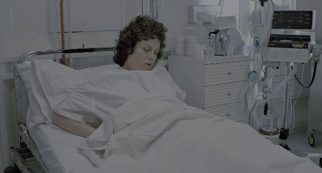Wide shot frame from Aliens — room, bed, bottle