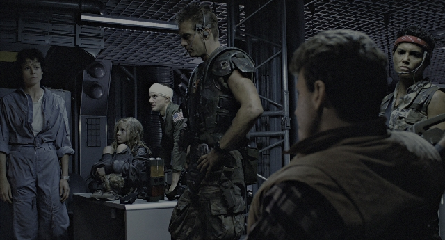 Wide shot frame from Aliens — sitting, standing, room