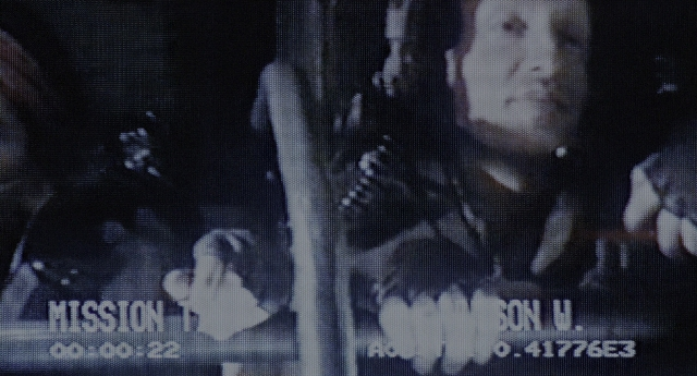 Wide shot frame from Aliens — room, face, person