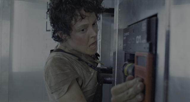 Wide shot frame from Aliens — standing, room, door