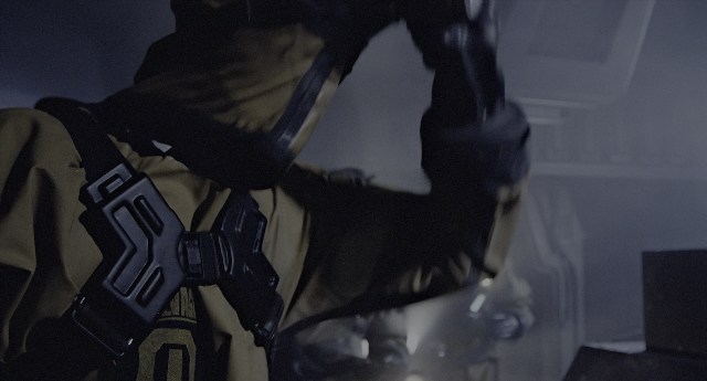 Wide shot frame from Aliens — room, hat, hand