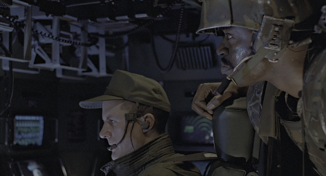 Wide shot frame from Aliens — sitting, standing, hat