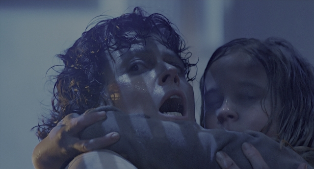 Wide shot frame from Aliens — room, face, hug