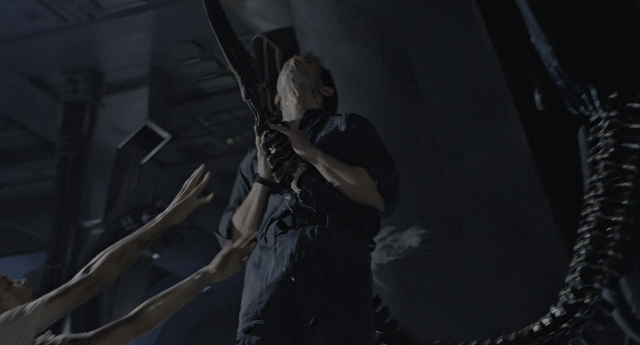 Wide shot frame from Aliens — standing, room, face