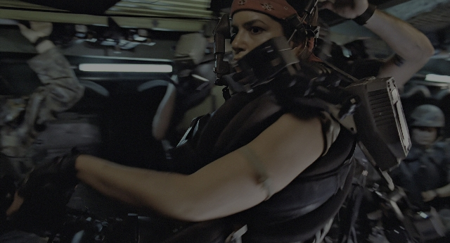 Wide shot frame from Aliens — hat, gun, boat