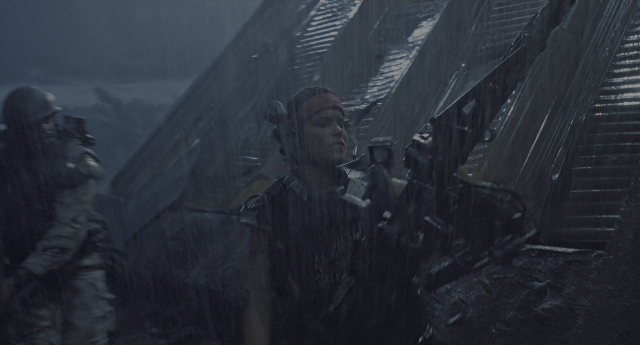 Wide shot frame from Aliens — standing, person, human face