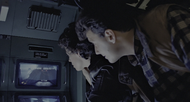 Wide shot frame from Aliens — standing, face, hair