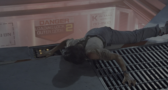 Wide shot frame from Aliens — door, shirt, person