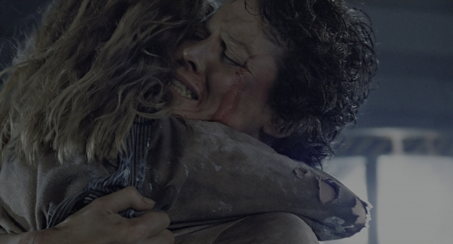Wide shot frame from Aliens — night, face, hair