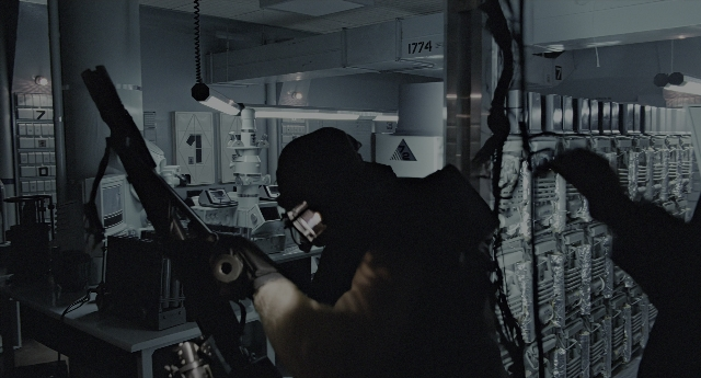 Wide shot frame from Aliens — standing, room, gun