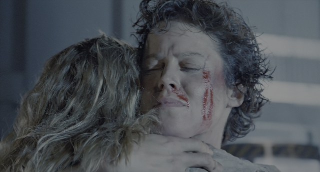 Wide shot frame from Aliens — coat, face, hair