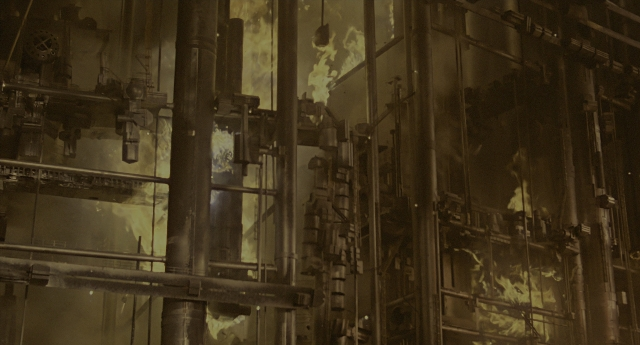 Wide shot frame from Aliens — smoke, building