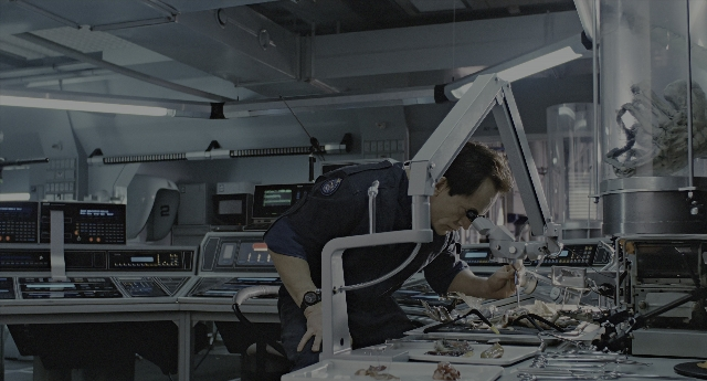 Wide shot frame from Aliens — standing, room, uniform