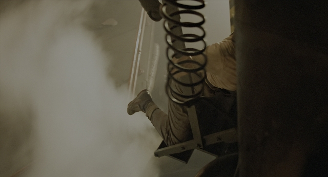 Wide shot frame from Aliens — hand, person, footwear