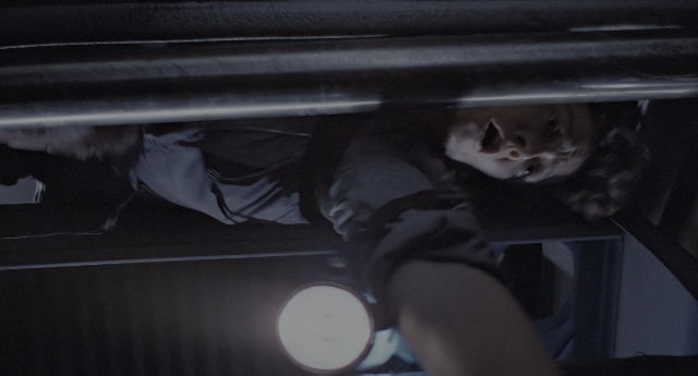 Wide shot frame from Aliens — bed, shirt, face