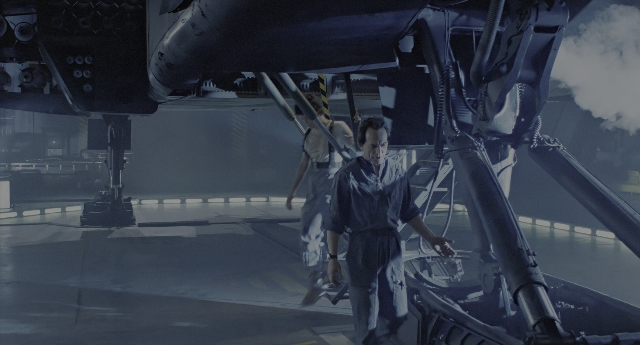 Medium shot frame from Aliens — standing, uniform, car