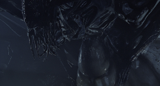 Wide shot frame from Aliens — face, smoke, statue sculpture