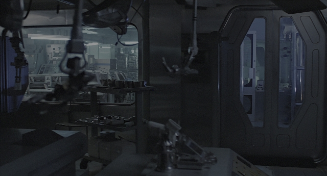 Wide shot frame from Aliens — room, table, door