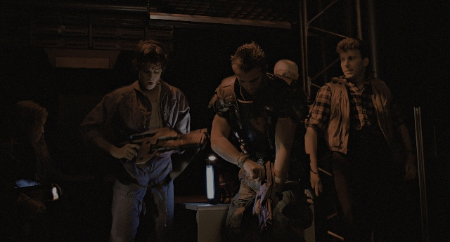 Wide shot frame from Aliens — sitting, standing, room