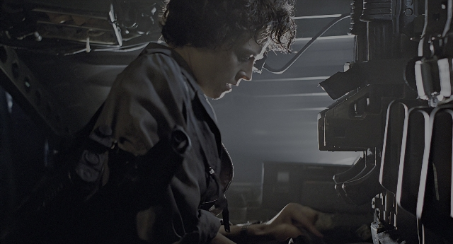 Wide shot frame from Aliens — sitting, room, door